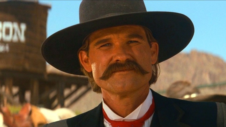 Kurt Russell as Wyatt Earp wearing a cowboy hat in Tombstone