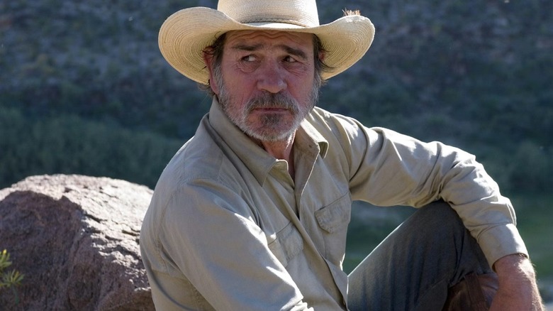 Pete sitting on a rock in "Three Burials"