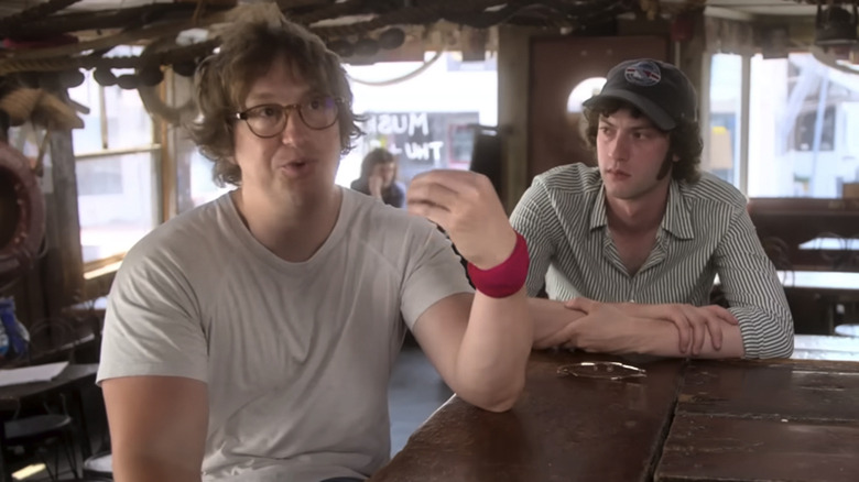 Tony director Matt Johnson speaking in a behind the scenes video, with Dominic Sessa sitting next to him