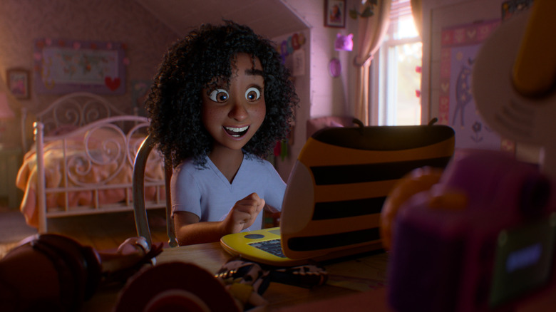 Mykal-Michelle Harris as the voice of Blaze looking excitedly at a laptop in her bedroom in Toy Story 5