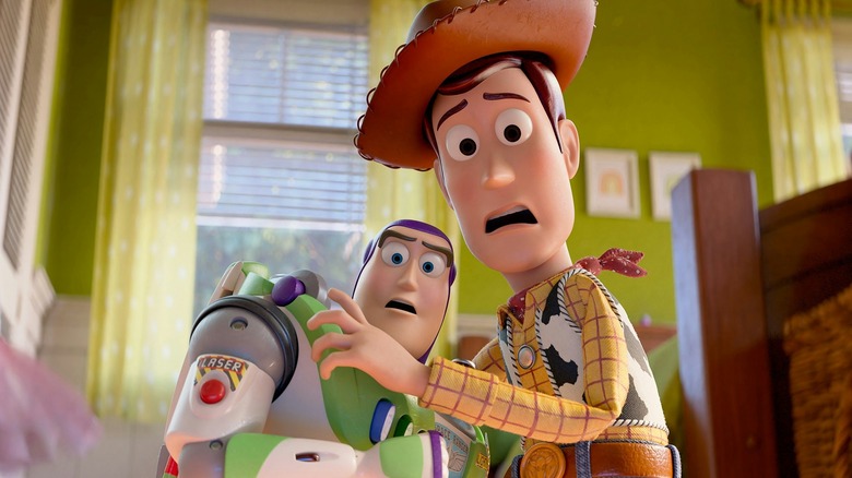 Buzz and Woody holding each other with a look of panic on their faces in Toy Story 5