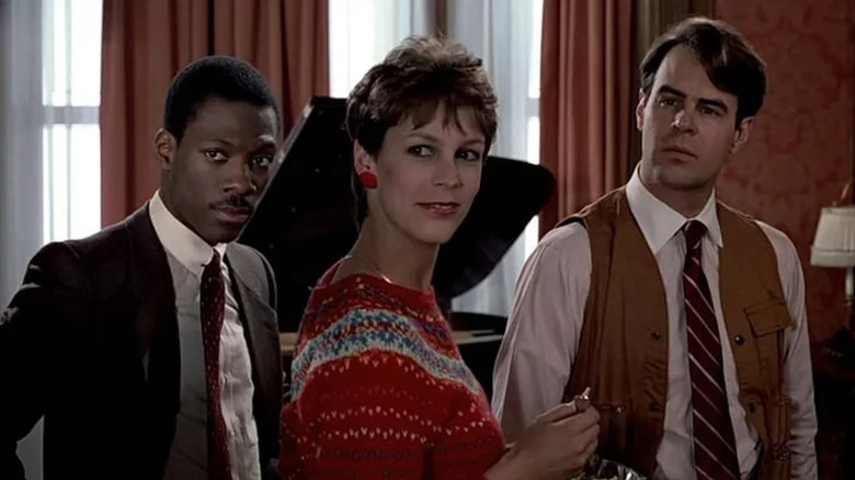 Valentine, Ophelia and Winthorpe standing in front of piano in Trading Places
