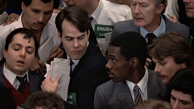 Winthorpe and Valentine standing on stock market floor in Trading Places