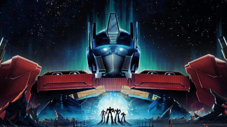 Optimus Prime looming over Cybertron on the Transformers One poster