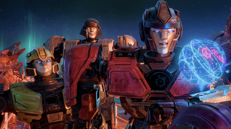 B-127, D-16, and Orion Pax standing together in Transformers One