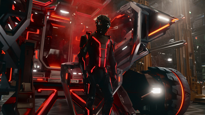 Ares standing in front of a lightcycle in Tron: Ares