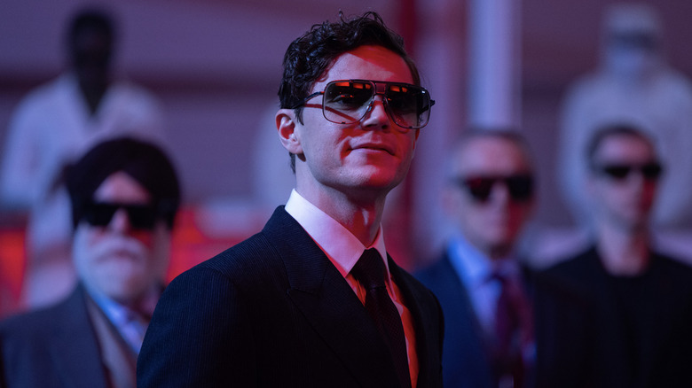 Evan Peters as Julian Dillinger in Tron: Ares watching the laser printing of his artificial intelligence soldiers