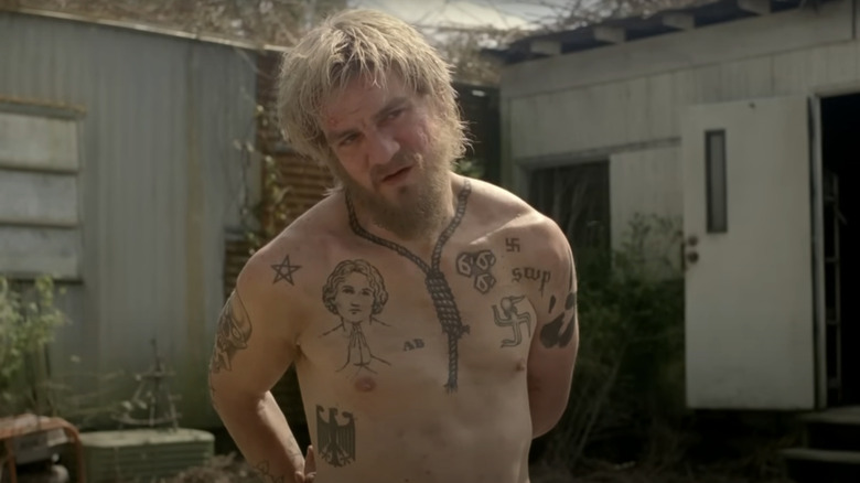 Charles Halford's Reggie Ledoux stands handcuffed in True Detective