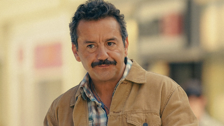 Armand (Max Casella) wearing a sandy colored jacket and checked shirt on 