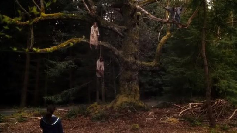 Abby looks at hanging bodies