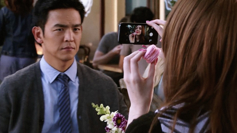 Eliza takes selfies while Henry looks on.