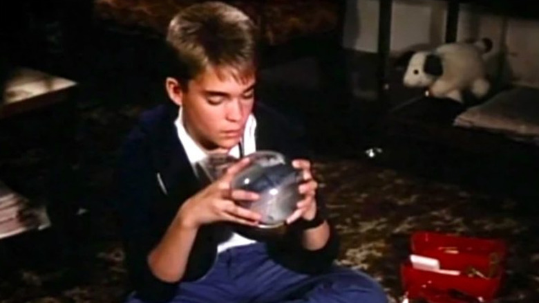 Tommy Westphall (Chad Allen) toys with a snow globe in the St. Elsewhere finale.