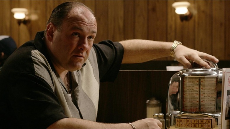 Tony Soprano (James Gandolfini) fusses with a tabletop jukebox in The Sopranos
