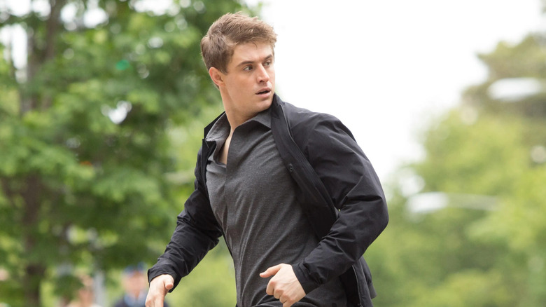 Max Irons as Joe Turner, running through the street on Three Days of Condor
