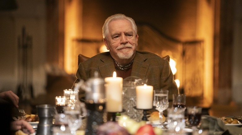 Brian Cox as Logan Roy, sitting at the head of a table on Succession
