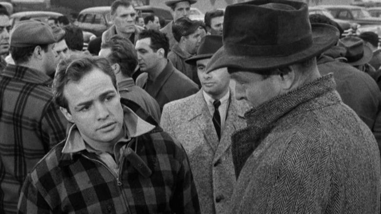 Terry Malloy talking to Inspectors Glover and Gillette in front of a crowd of longshoremen in On the Waterfront
