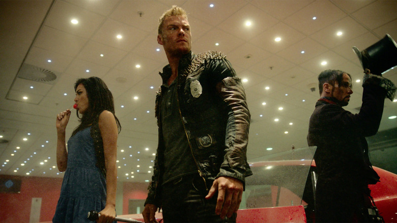 Grace, Arthur, and Julian Slink in a showroom on the TV series Blood Drive