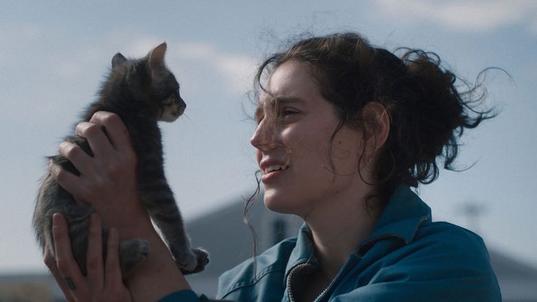 Agnes holding a kitten and smiling in Sorry, Baby