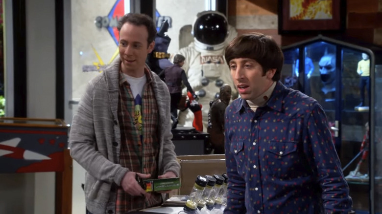Stuart and Howard looking at something off camera in the comic book shop on The Big Bang Theory