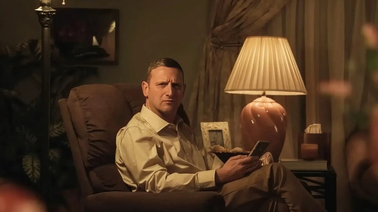 Craig sitting in his car with his phone in his hand looking confused in Friendship