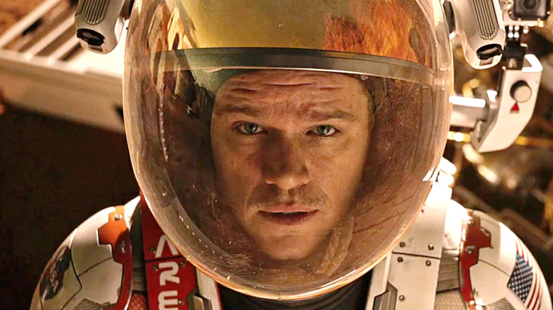 Matt Damon as Mark Watney looking up with his space suit on in The Martian