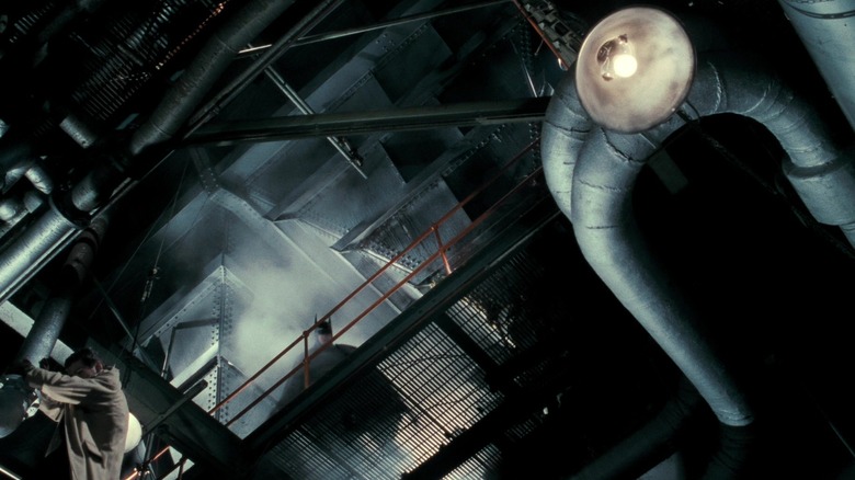 MIchael Keaton's Batman peers over a railing in Axis Chemicals in Batman