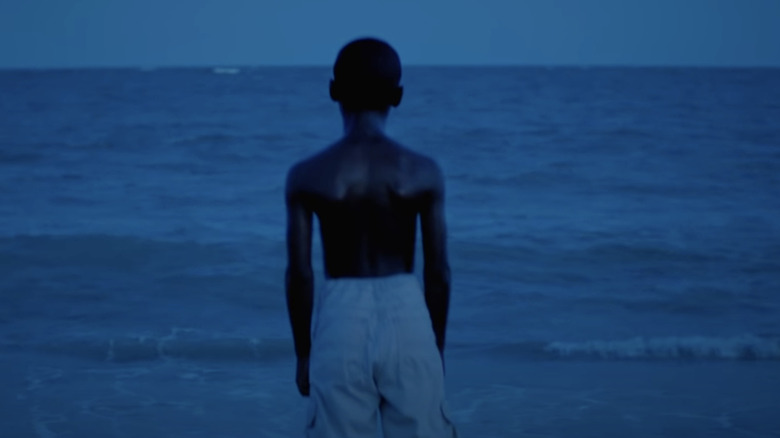 Alex Hibbert stands on the beach in Moonlight