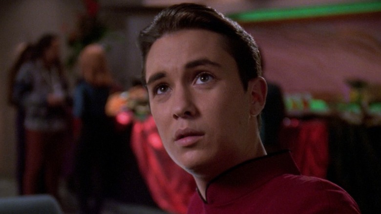 Wil Wheaton sitting at the table in the Star Trek: The Next Generation episode Journey's End