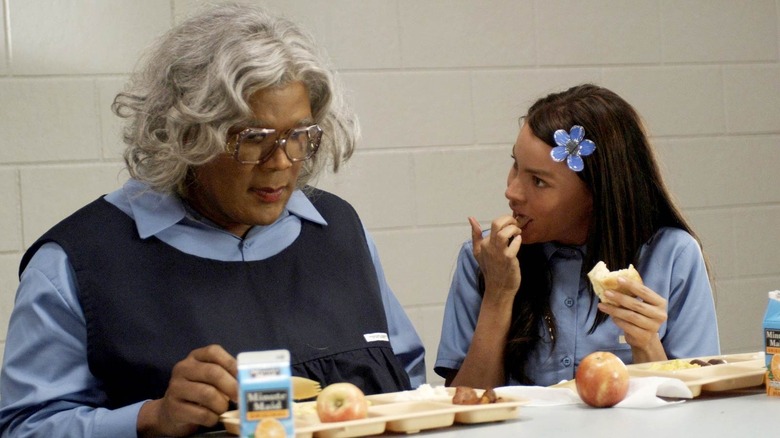 Madea Simmons (Tyler Perry) sits in a prison cafeteria with T.T. (Sofia Vergara) in Madea Goes to Jail