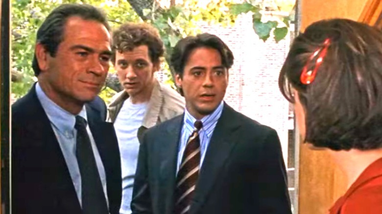 Tommy Lee Jones and Robert Downey Jr. stand in a doorway