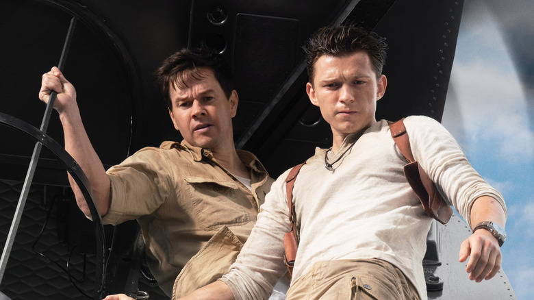 Nathan Drake and Victor Sullivan looking down out of a helicopter in Uncharted