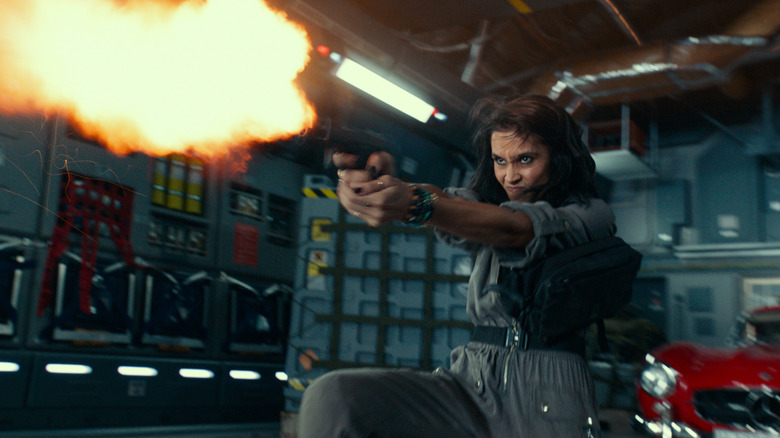 Chloe firing a pistol inside a cargo plane in Uncharted