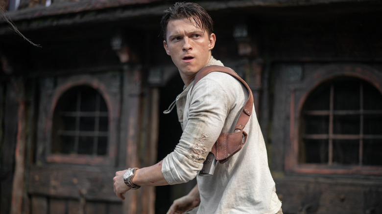 Nathan Drake spinning around on a pirate ship with a shocked expression on his face in Uncharted