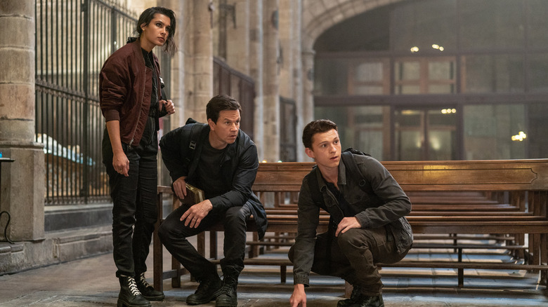 Nate, Sully, and Chloe investigating an old church in the Uncharted movie