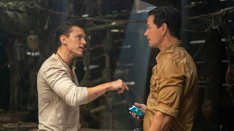 Nathan Drake talking angrily to Sully inside a pirate ship in Uncharted
