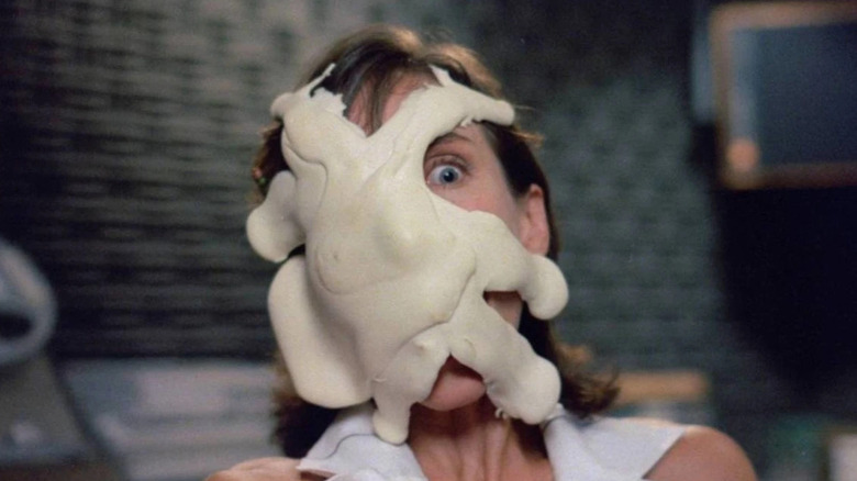A woman has white goo covering her face in The Stuff