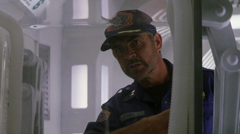 William T. O'Niel (Sean Connery) peers through machinery in Outland