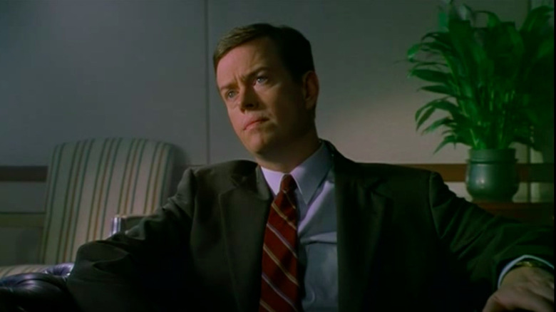 Dylan Baker seated suit