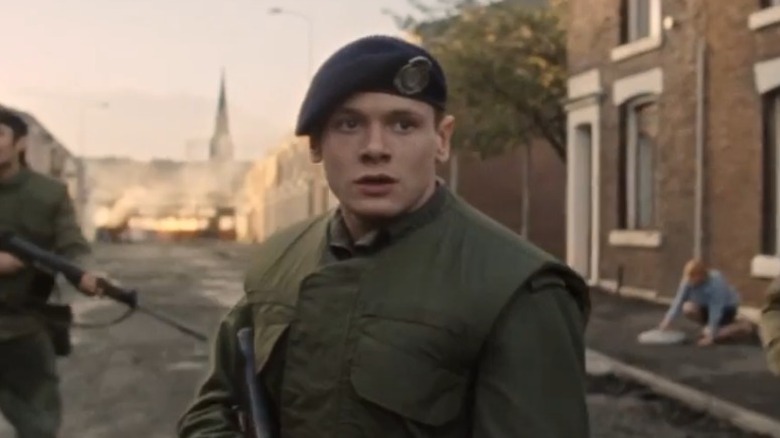Jack O'Connell holding gun