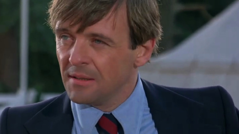 Captain Johnson in a blue suit and red tie
