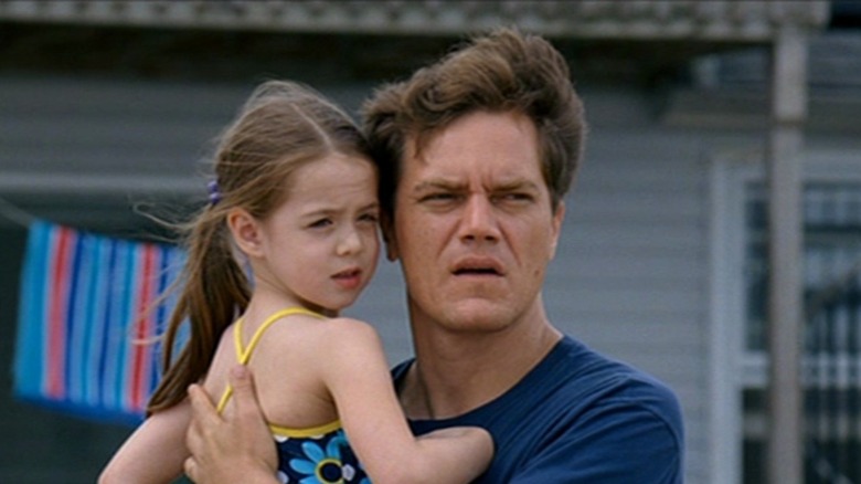 Michael Shannon holds a child in Take Shelter