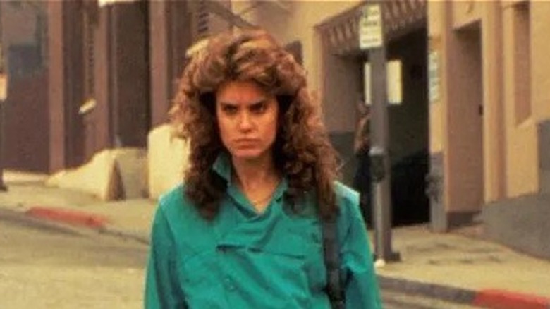 Young woman stands in street in Night of the Comet