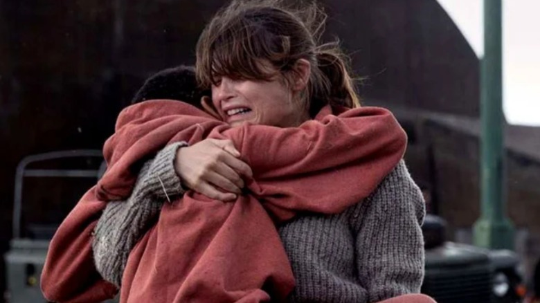 woman running with a child in her arms
