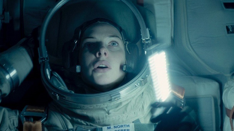 An astronaut looks on in horror and awe