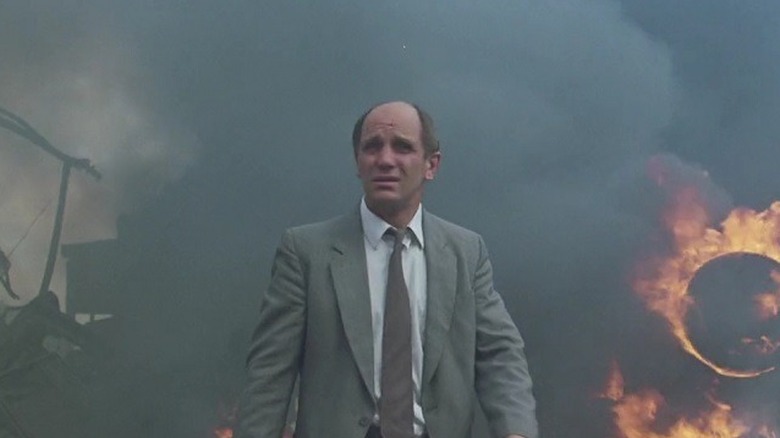 Zac wanders through the flaming hull of a plane