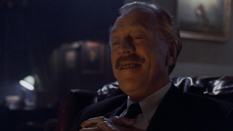 Leland Gaunt sits in his office