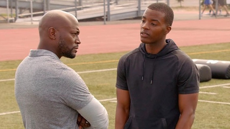 All American: Coach Baker (Taye Diggs) and Spencer (Daniel Ezra) talk on football field