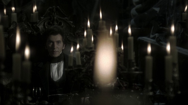 Count Dracula surrounded by candles