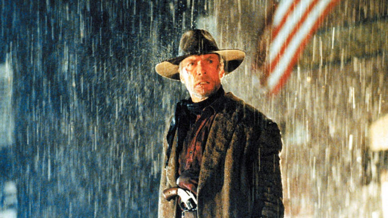 Clint Eastwood standing in the rain in Unforgiven