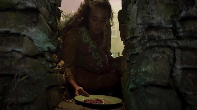 The expecting mother leaves an offering for the "Redcaps"